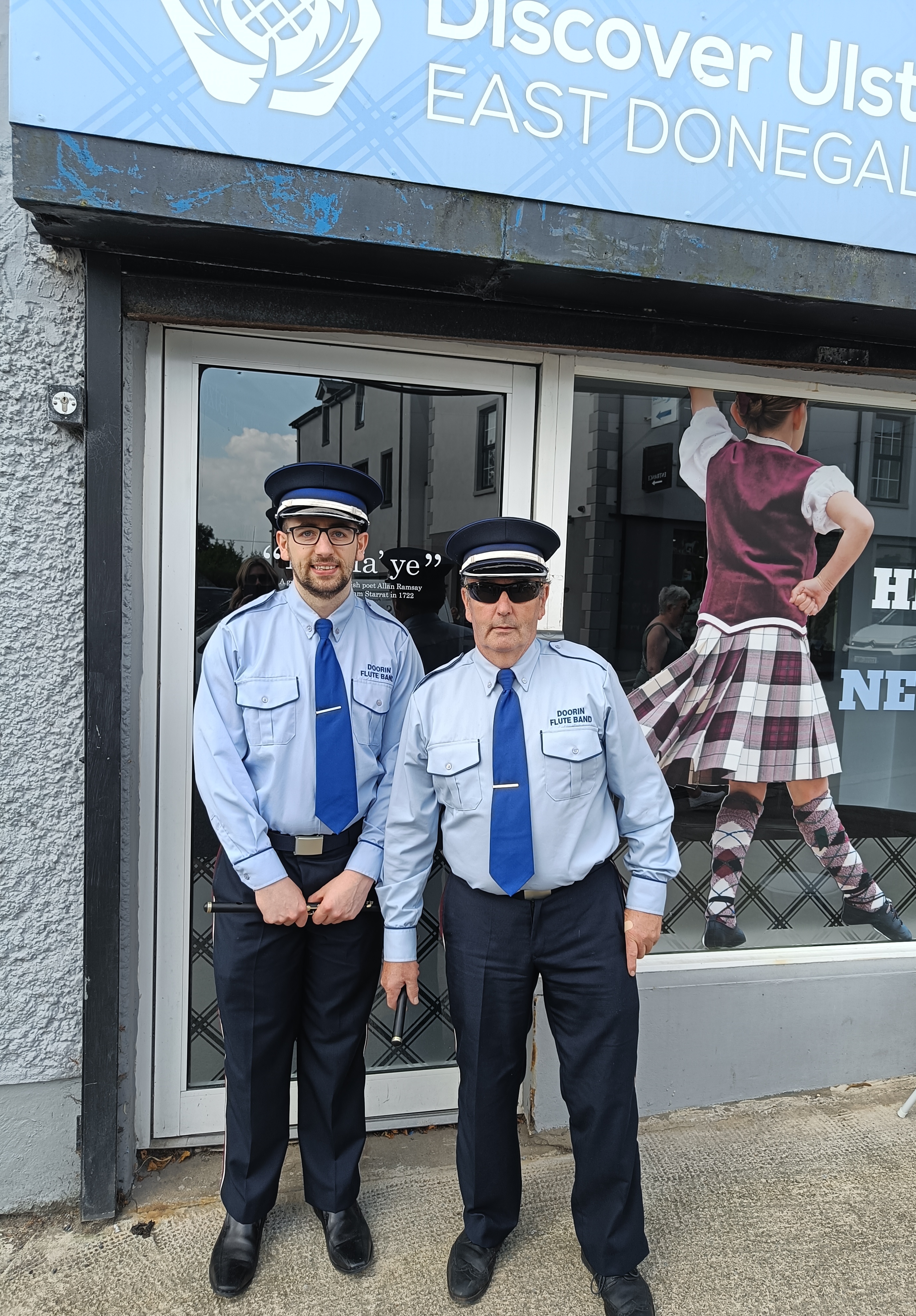 Two members of Doorin Flute Band stand outside the Ulster-Scots Agency office in Raphoe, Co Donegal